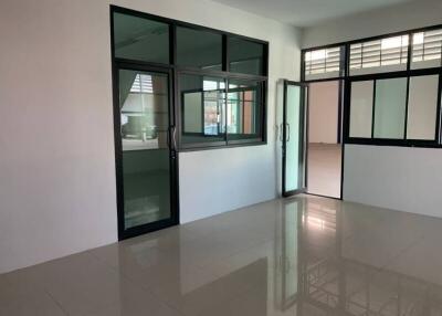 Spacious unfurnished office or room with large windows and glossy floor tiles