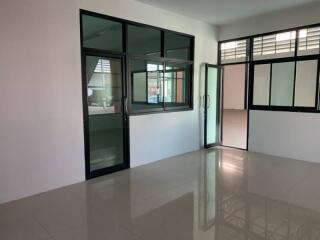 Spacious unfurnished office or room with large windows and glossy floor tiles