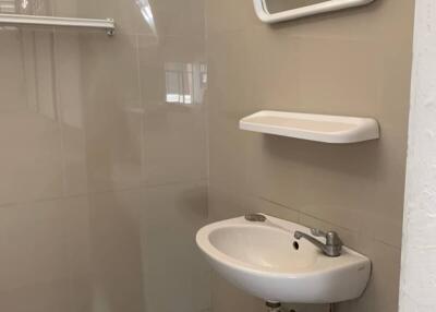 Bathroom with sink, mirror, shelf, and towel rack