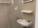 Bathroom with sink, mirror, shelf, and towel rack