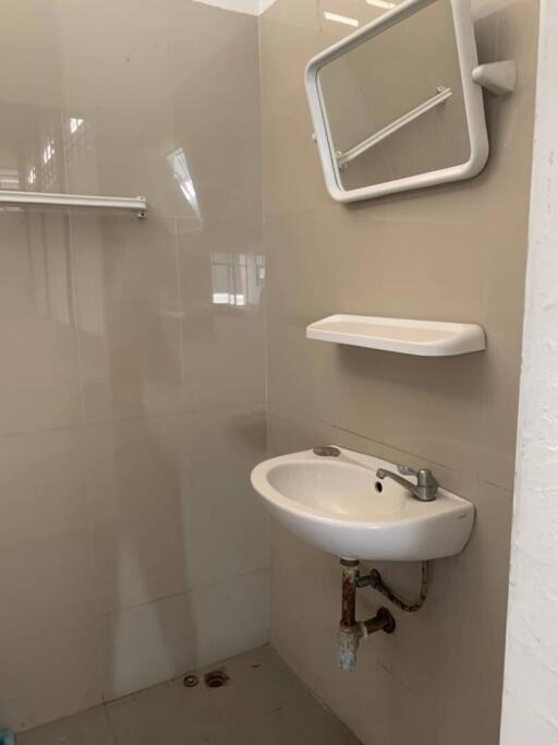 Bathroom with sink, mirror, shelf, and towel rack