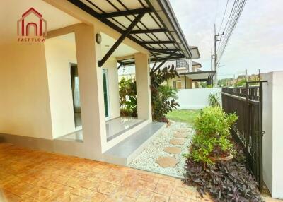 Front view of house with covered patio and garden area