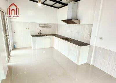 modern white kitchen with stainless steel exhaust hood