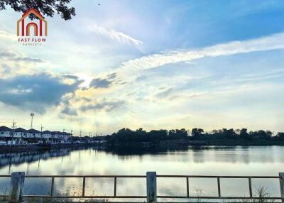 Scenic view of lake with houses in the background