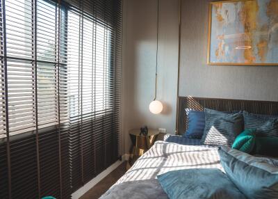 Modern bedroom with large windows and blinds