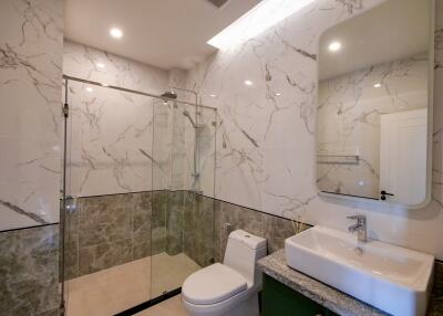 Modern bathroom with glass shower and marble accents