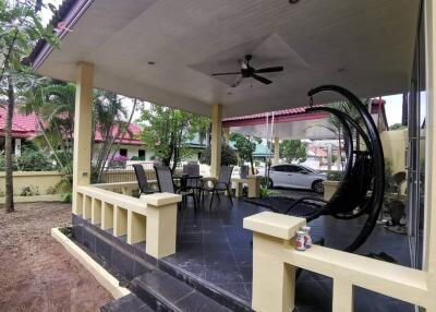 Outdoor patio with seating and hanging chair