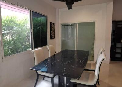 Modern dining room with black table and white chairs