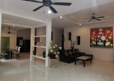 Modern living room with ceiling fans and art decor