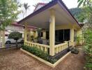 Exterior view of a yellow house with a front porch