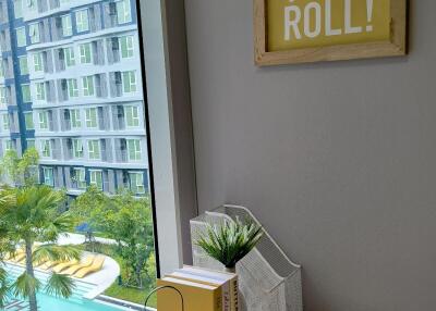 Bedroom with a desk and a view of the pool and apartment building