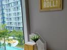 Bedroom with a desk and a view of the pool and apartment building