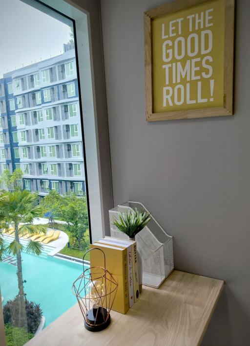 Bedroom with a desk and a view of the pool and apartment building