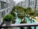 View from the balcony overlooking the pool and surrounding buildings