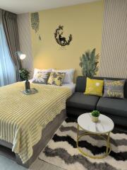 Cozy bedroom with a comfortable bed, decorative pillows, sofa, and modern decor