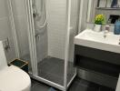 Modern bathroom with shower, toilet, sink, and playful mat