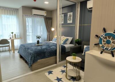 Modern bedroom with large window, bed, desk, and mirrored closet