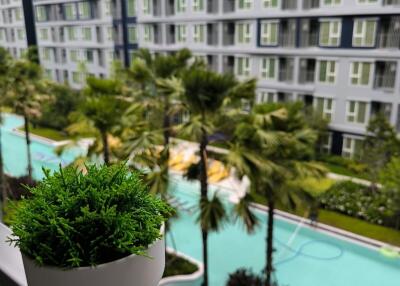 View from balcony overlooking pool and apartment complex