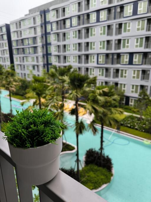 View from balcony overlooking pool and apartment complex