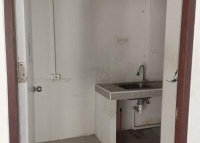 Small kitchen area with sink and tiled floor