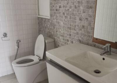 Modern bathroom with tiled walls and fixtures