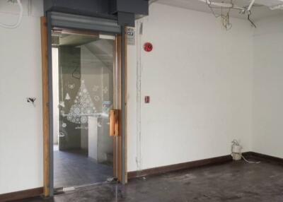 empty room with visible ceiling wiring and doorway