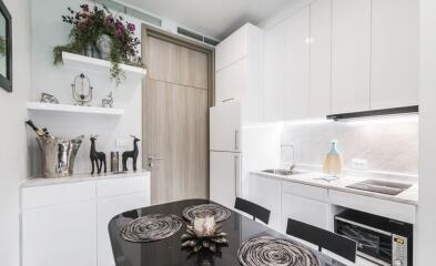 Modern kitchen with white cabinets and dining area