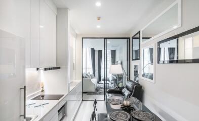 Modern white kitchen with adjoining living area