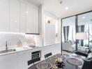 Modern kitchen and living room with sleek white cabinetry, dining table, and cozy seating area