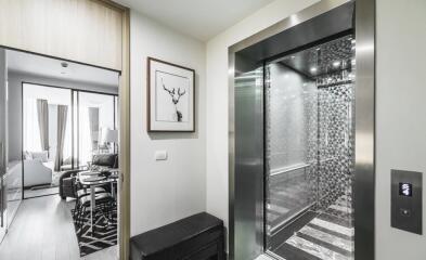 Modern elevator adjacent to a stylish living room and dining area