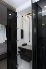 Walk-in closet with black sliding glass doors