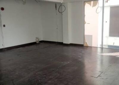 Unfurnished room with dark flooring and large windows