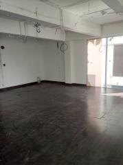 Unfurnished room with dark flooring and large windows