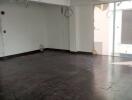 Unfurnished room with dark flooring and large windows