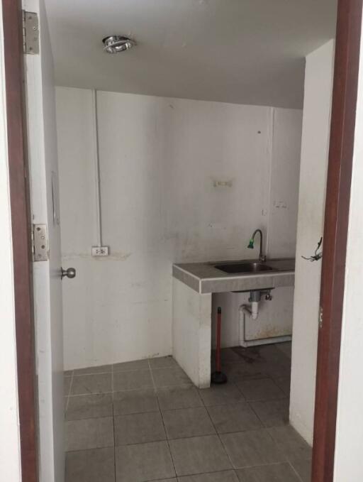 Utility room with sink and tiled floor