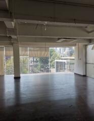 Spacious empty room with large windows and city view