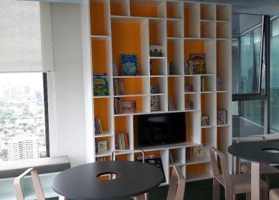 Modern living area with bookshelves and seating arrangements