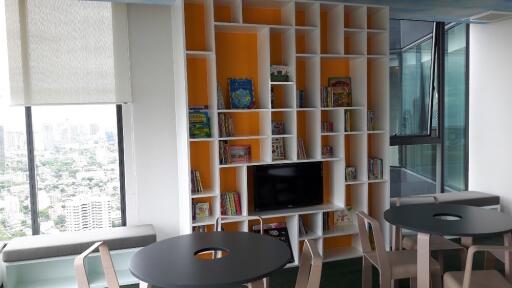 Modern living area with bookshelves and seating arrangements