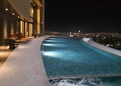 Rooftop swimming pool with city view at night