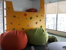 Bright living space with rock climbing wall and bean bags