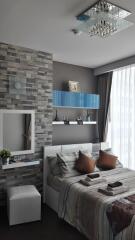 Modern bedroom with a bed, decorative shelves, and a stylish wall clock