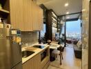 Compact modern kitchen leading to an open living area with city views