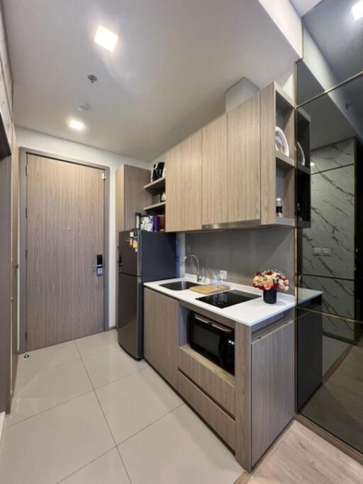 Modern kitchen with wooden cabinets and stainless steel appliances