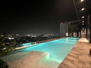 Rooftop Infinity Pool with Night City View