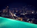 Night view of city skyline from rooftop swimming pool