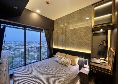 Modern bedroom with large windows and city view