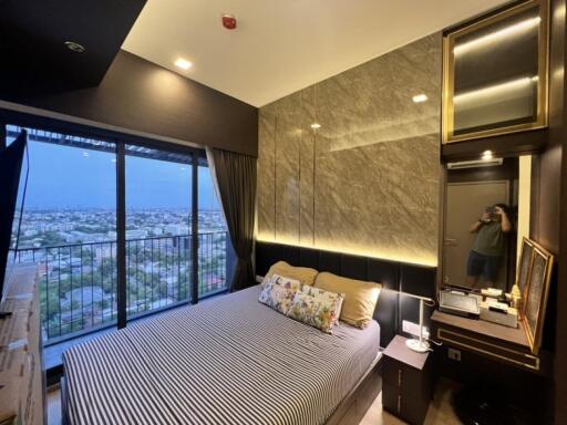 Modern bedroom with large windows and city view