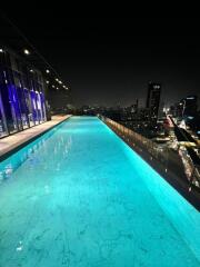 Rooftop pool with city view at night