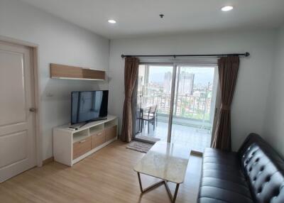 Spacious living room with balcony access and city view