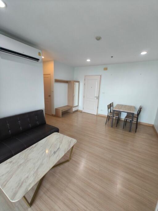 Modern living room with dining area and air conditioning